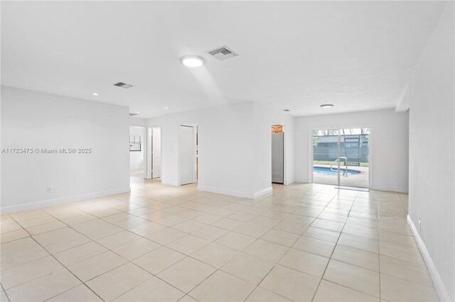 tiled empty room with a wall mounted AC