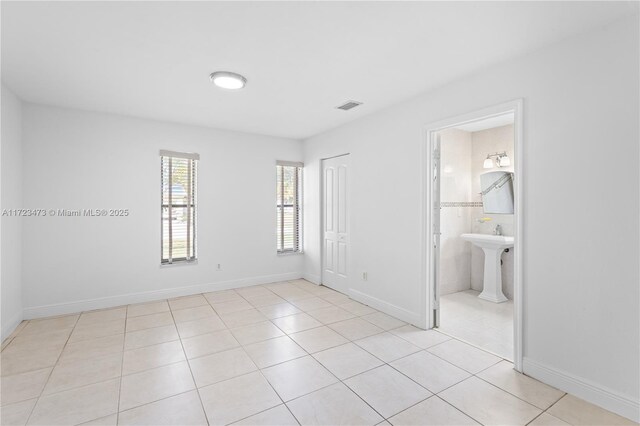 empty room with light tile patterned floors