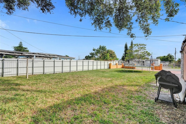 view of yard with a trampoline