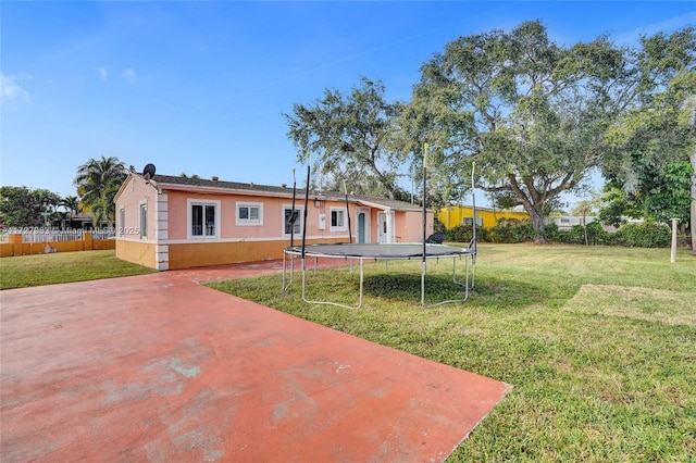 exterior space featuring a front yard and a trampoline