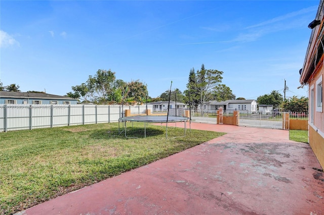 view of yard featuring a patio area and a trampoline