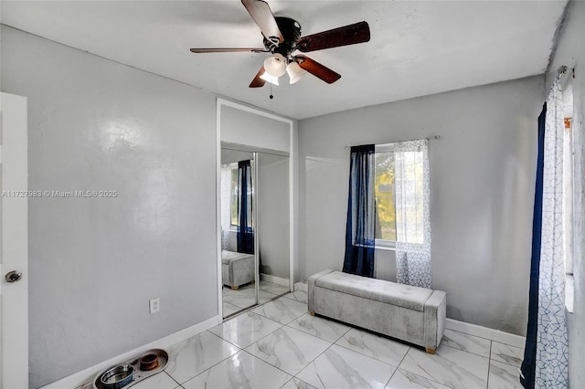 bedroom with ceiling fan and a closet