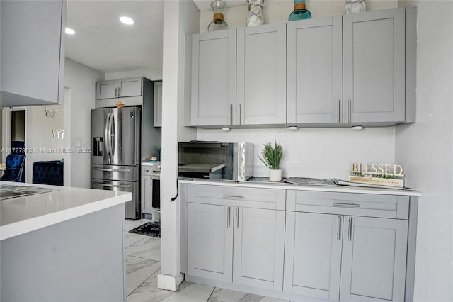 kitchen with stainless steel fridge and gray cabinets