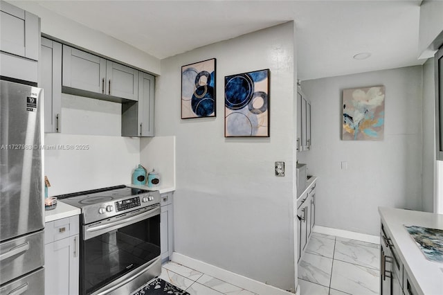 kitchen with appliances with stainless steel finishes and gray cabinetry