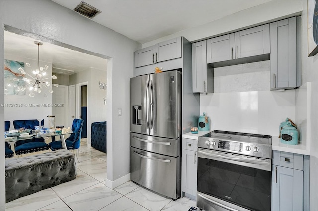 kitchen featuring appliances with stainless steel finishes, gray cabinetry, hanging light fixtures, and a notable chandelier