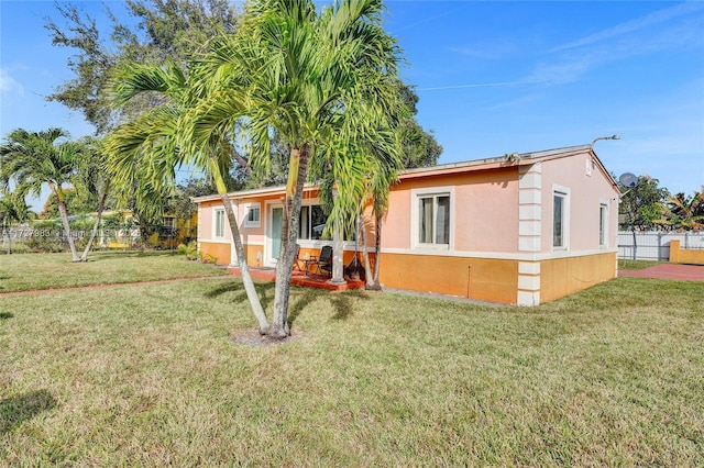 rear view of house with a yard