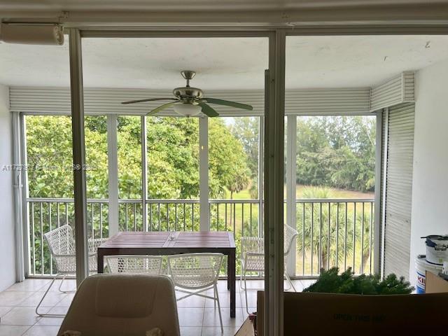 sunroom / solarium featuring ceiling fan and a healthy amount of sunlight