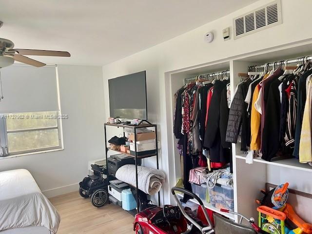 bedroom with ceiling fan and light hardwood / wood-style flooring