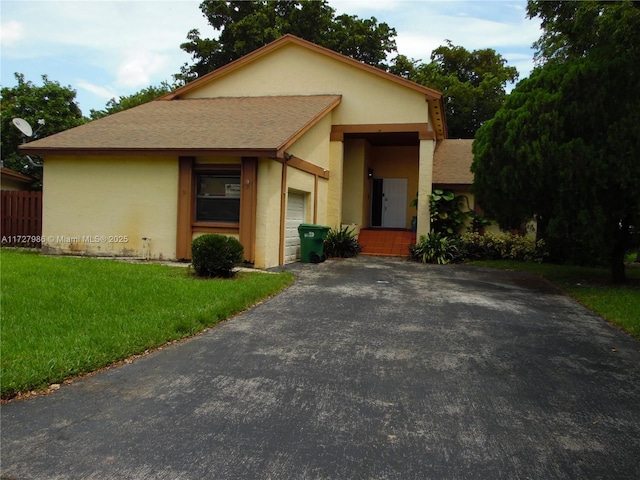 view of front of house with a garage and a front yard