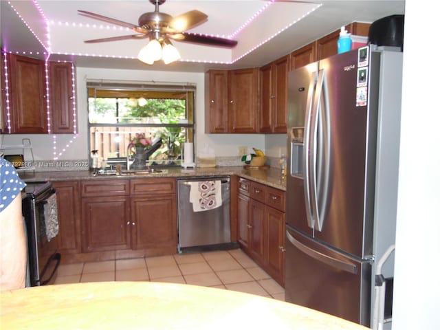 kitchen featuring ceiling fan, sink, light tile patterned flooring, stainless steel appliances, and light stone counters