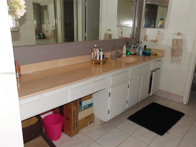 bathroom with tile patterned floors and vanity