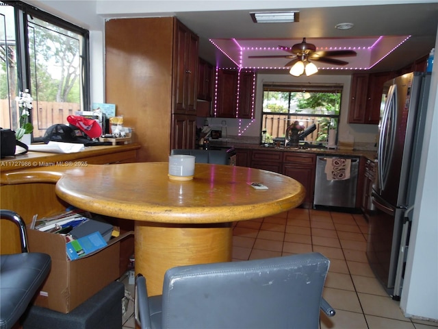 kitchen with ceiling fan, light tile patterned floors, appliances with stainless steel finishes, and sink