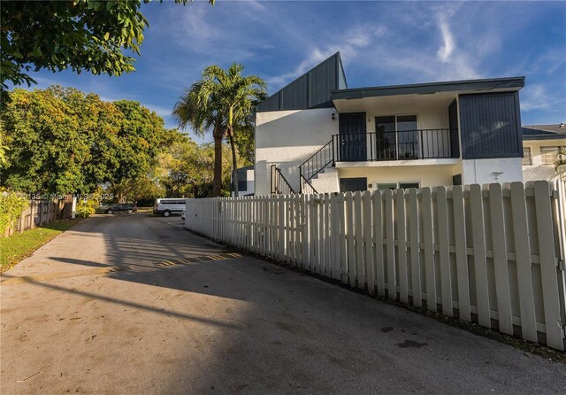 view of side of home featuring a balcony