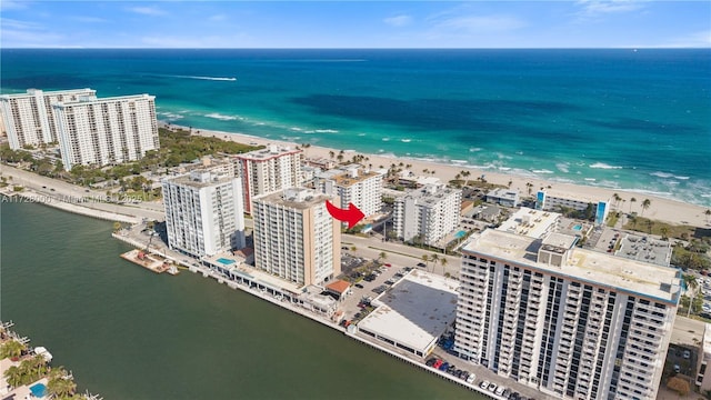 birds eye view of property with a water view and a view of the beach