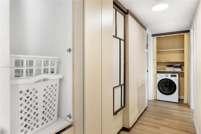 laundry room with washer / clothes dryer and light hardwood / wood-style flooring