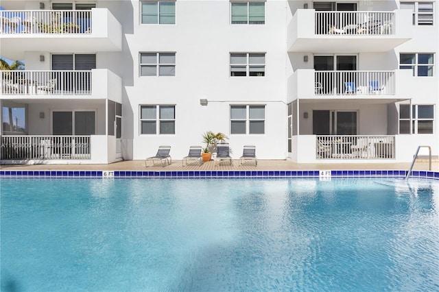 view of pool featuring a water view and central AC