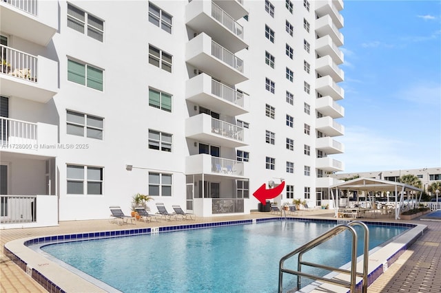 view of swimming pool with a gazebo and a patio