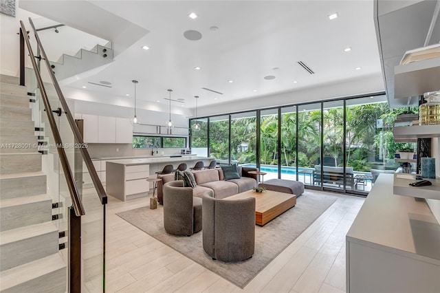 living room featuring floor to ceiling windows and light hardwood / wood-style floors