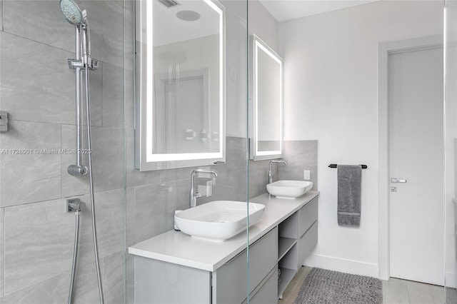 bathroom featuring vanity and a tile shower