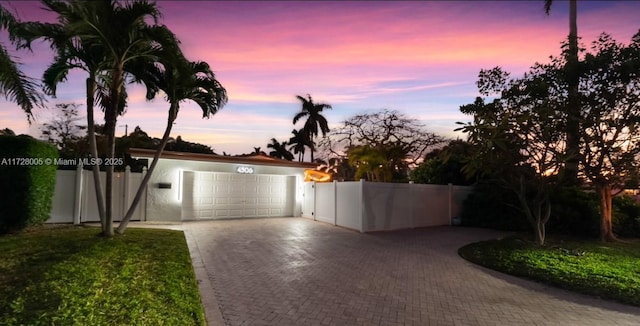 view of garage at dusk