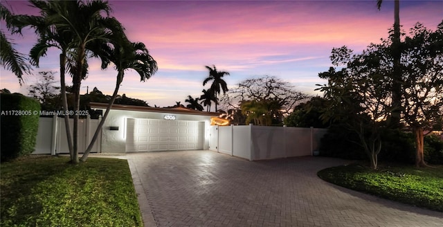 view of garage at dusk