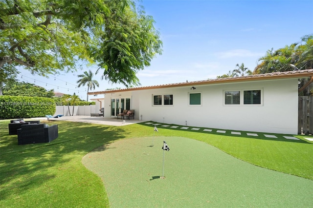 rear view of property with an outdoor hangout area and a patio