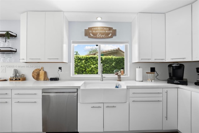 kitchen featuring dishwasher, white cabinets, and sink