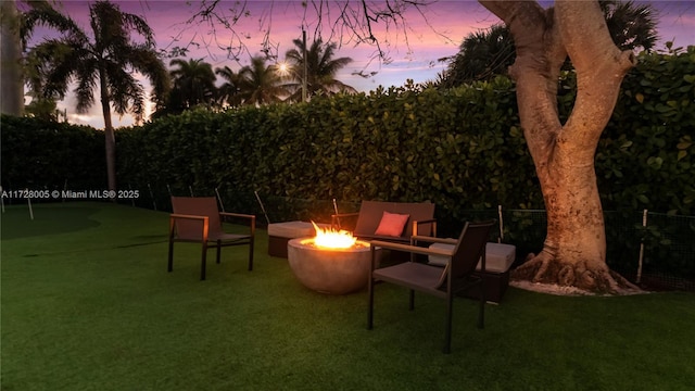 patio terrace at dusk featuring a fire pit