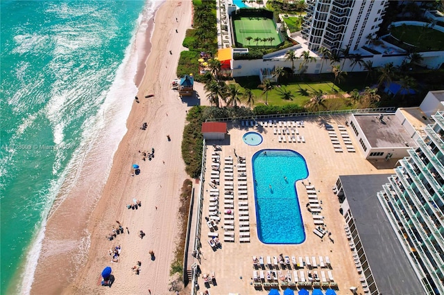 drone / aerial view featuring a water view and a beach view