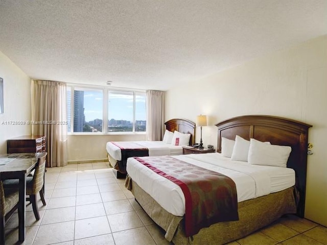 tiled bedroom featuring a textured ceiling