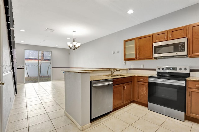 kitchen featuring light tile patterned floors, a notable chandelier, sink, and stainless steel appliances