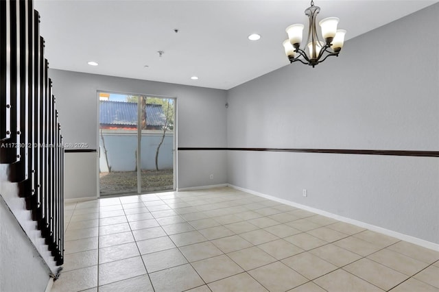 unfurnished room featuring light tile patterned flooring and an inviting chandelier