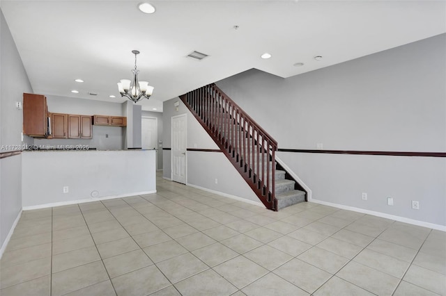 unfurnished living room featuring light tile patterned floors and a chandelier