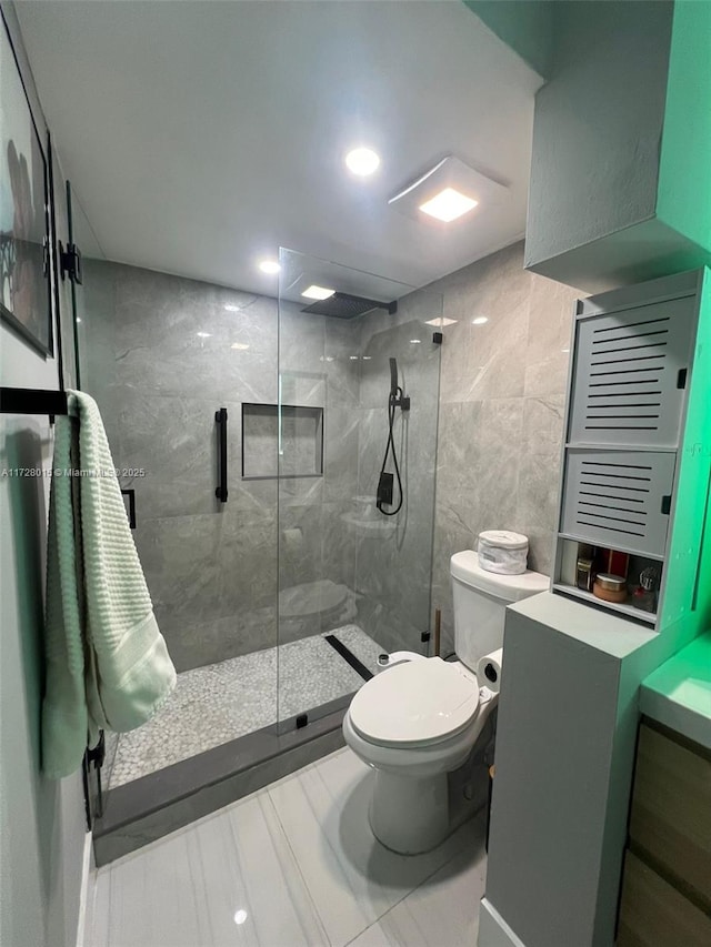 bathroom featuring tile walls, toilet, walk in shower, and tile patterned flooring