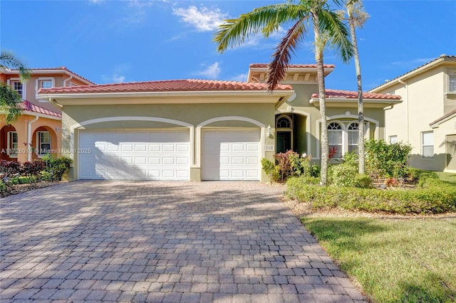 mediterranean / spanish home with a garage