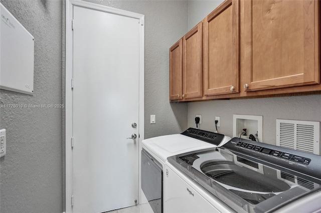 laundry area featuring cabinets and washer and dryer