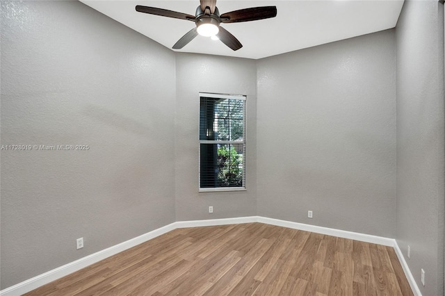 empty room featuring light wood-type flooring and ceiling fan