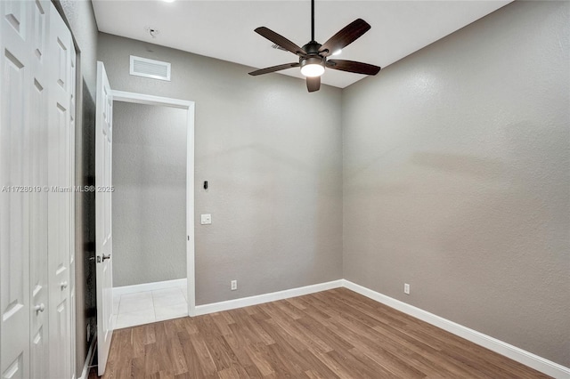 unfurnished bedroom with ceiling fan and hardwood / wood-style floors