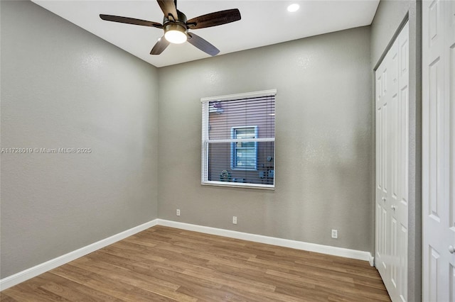 unfurnished bedroom with ceiling fan and light wood-type flooring