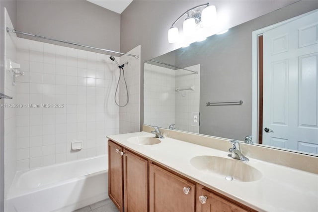 bathroom featuring vanity, tile patterned flooring, and tiled shower / bath combo