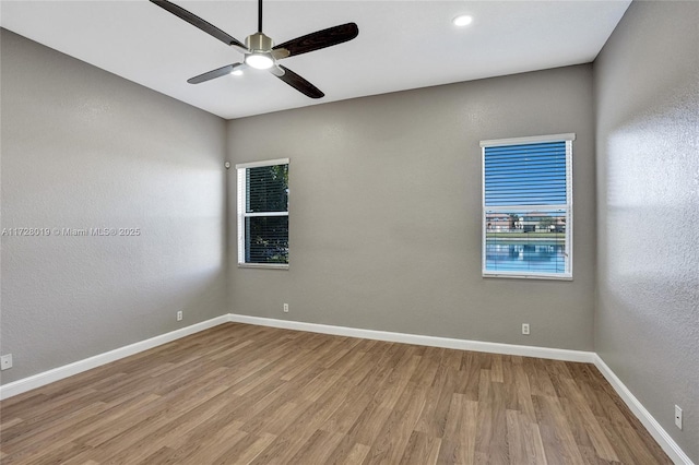 empty room featuring ceiling fan and light hardwood / wood-style floors