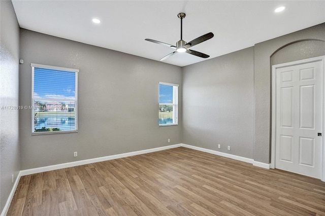 spare room featuring ceiling fan and light hardwood / wood-style flooring