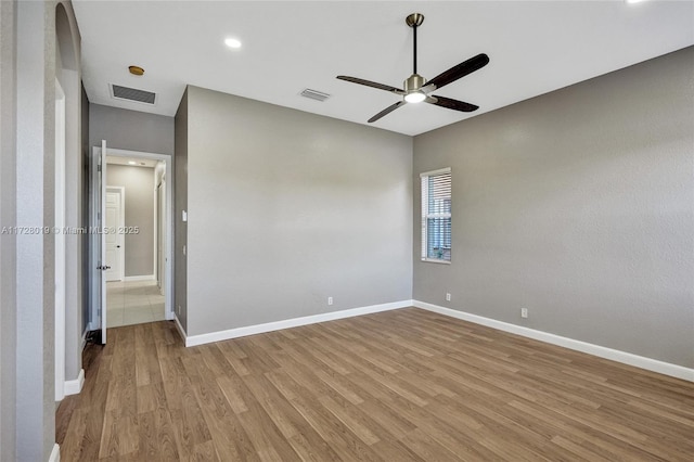 spare room featuring ceiling fan and light hardwood / wood-style flooring