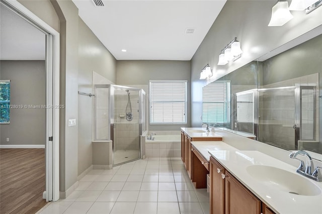 bathroom with tile patterned flooring, shower with separate bathtub, and vanity