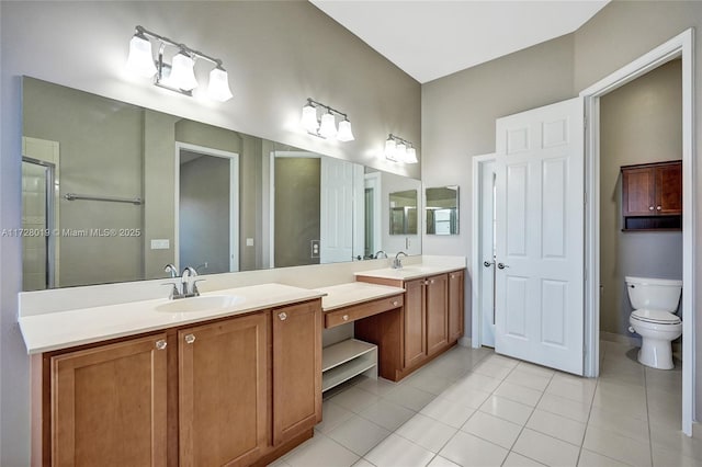 bathroom featuring toilet, vanity, and tile patterned flooring