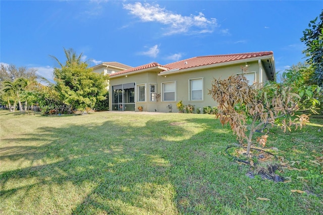 rear view of property with a yard