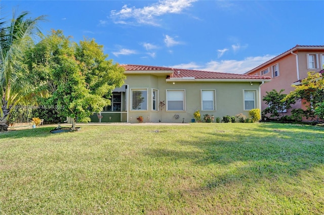 back of house with a lawn