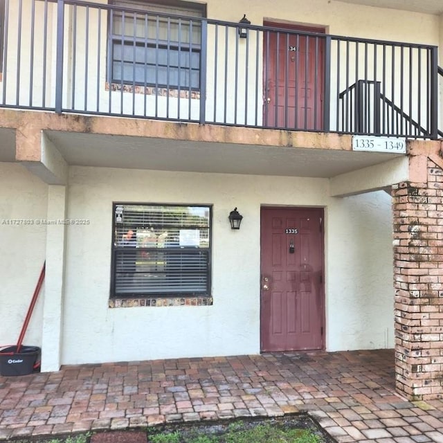 entrance to property with a balcony