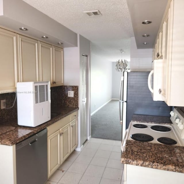 kitchen featuring tasteful backsplash, black dishwasher, range with electric cooktop, light tile patterned floors, and cream cabinetry