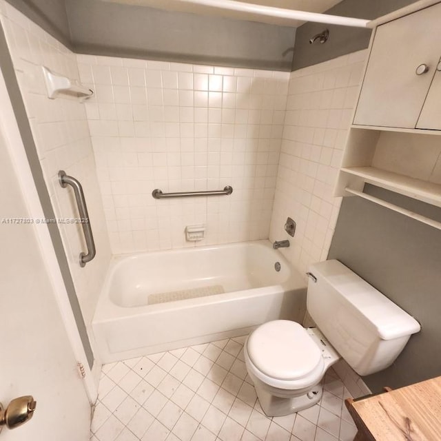 bathroom with tile patterned floors, toilet, and tiled shower / bath